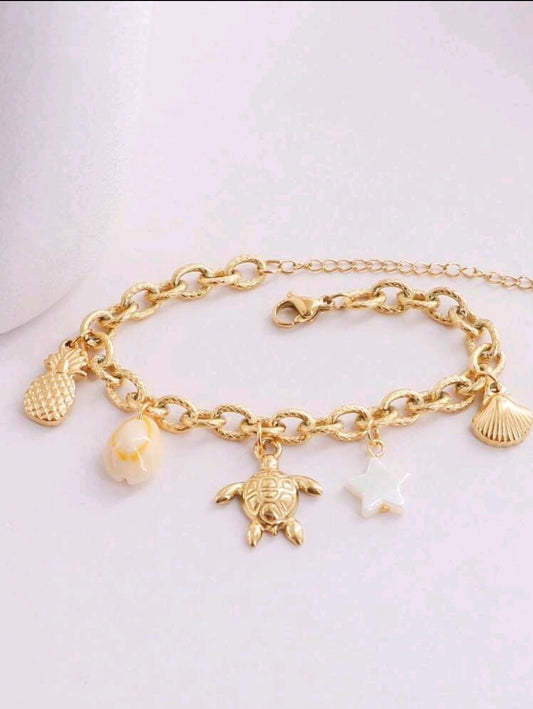Pulsera dorada con dijes marinos. Acero Inoxidable chapado en oro